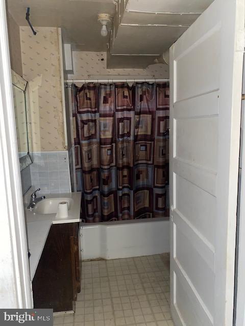 bathroom with vanity and shower / bath combo with shower curtain