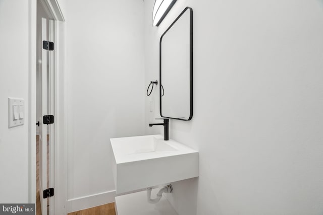 bathroom with hardwood / wood-style flooring