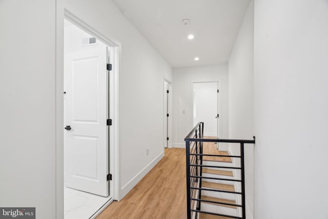 hall with hardwood / wood-style flooring