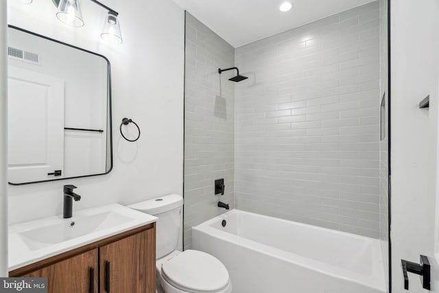 full bathroom with vanity, toilet, and tiled shower / bath combo