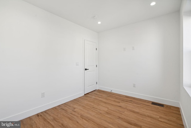 unfurnished room with hardwood / wood-style floors