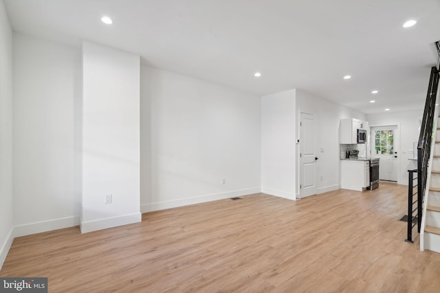 unfurnished living room with light hardwood / wood-style flooring