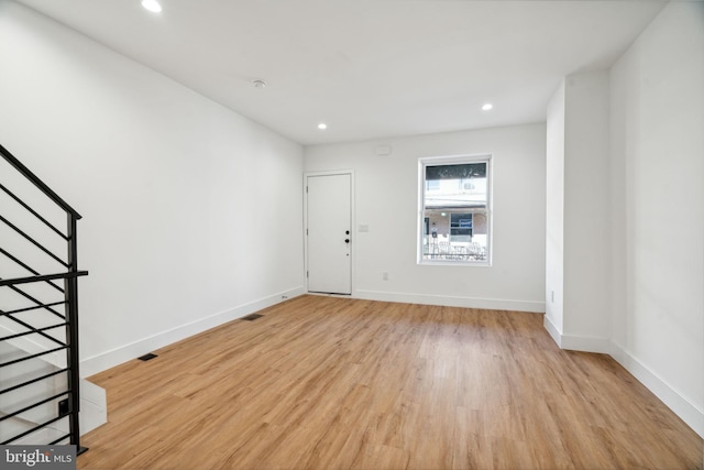 spare room with light hardwood / wood-style floors