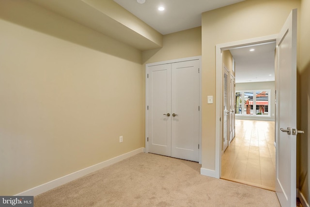 hallway with light colored carpet