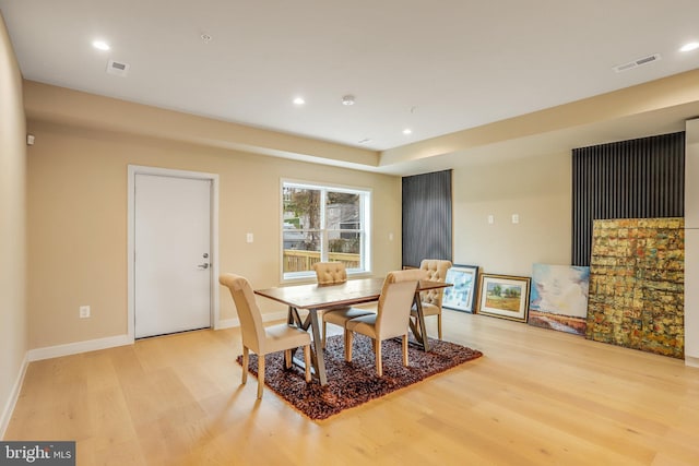 dining space with light hardwood / wood-style flooring