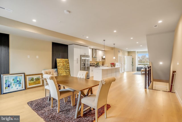 dining space with light hardwood / wood-style flooring