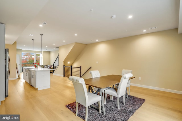 dining space featuring light wood-type flooring