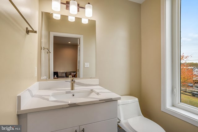 bathroom featuring vanity and toilet