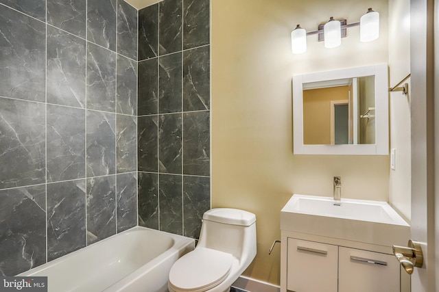 full bathroom featuring vanity, tiled shower / bath combo, and toilet