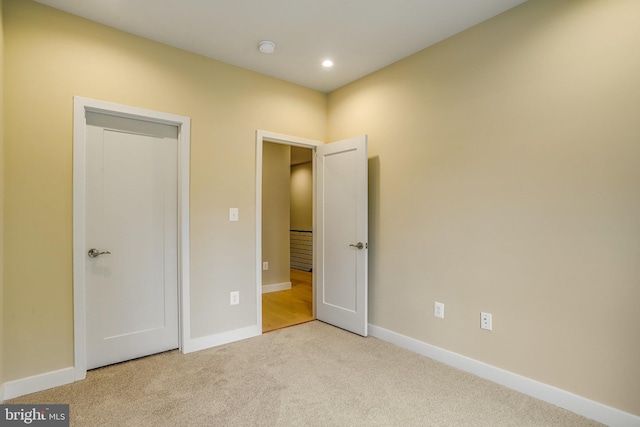 unfurnished bedroom featuring light carpet