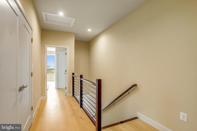 hallway with light hardwood / wood-style floors