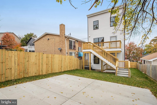 back of house featuring a lawn and a patio