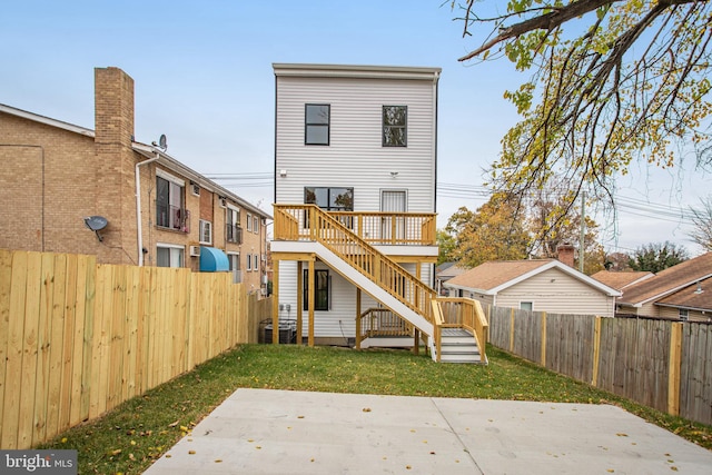 back of property with a lawn, a patio area, cooling unit, and a deck