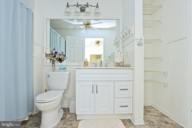 bathroom with vanity, toilet, a shower with shower curtain, and ceiling fan