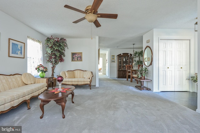 living room featuring a textured ceiling and ceiling fan