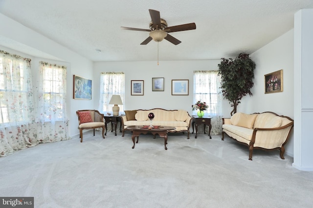 living area featuring ceiling fan and light colored carpet