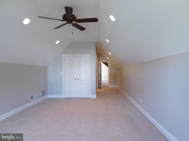 bonus room with light carpet, lofted ceiling, and ceiling fan