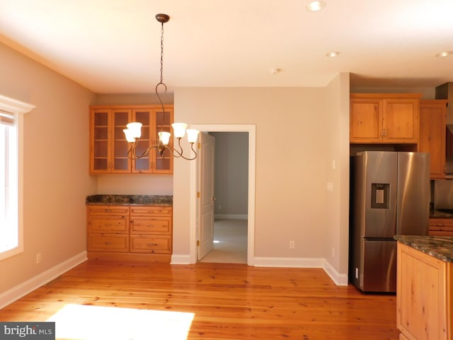 kitchen with pendant lighting, stainless steel fridge, plenty of natural light, and light wood-type flooring