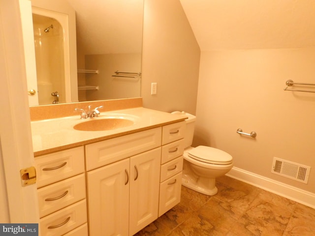 bathroom with vanity, lofted ceiling, and toilet