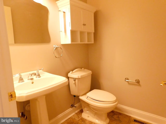 bathroom with toilet and tile patterned floors