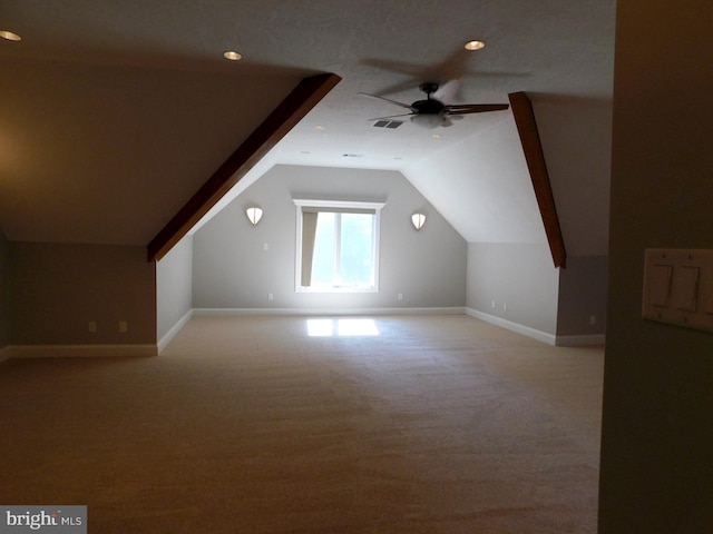 bonus room with light carpet, lofted ceiling, and ceiling fan