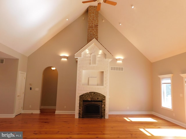 unfurnished living room with ceiling fan, high vaulted ceiling, and hardwood / wood-style floors