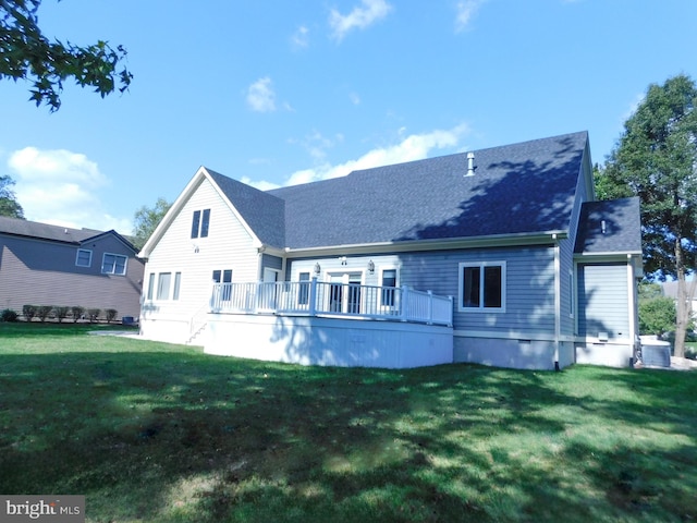 back of property with a wooden deck and a lawn