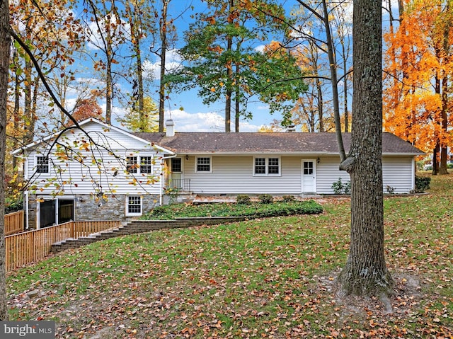 back of property featuring a lawn