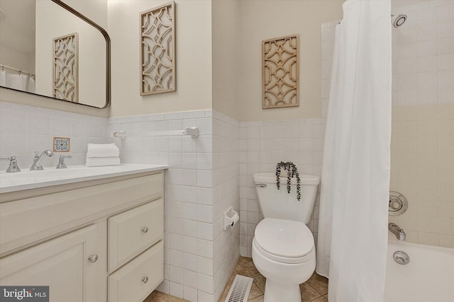 full bathroom featuring tile patterned flooring, vanity, tile walls, and toilet