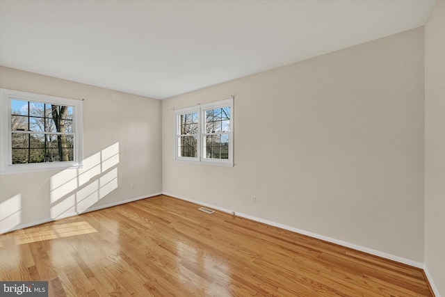 spare room with light wood-type flooring