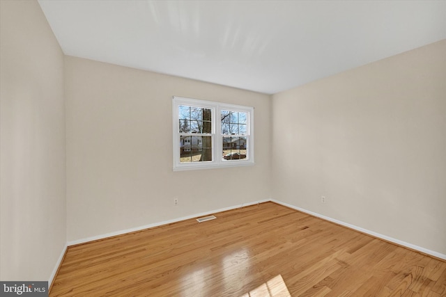 spare room with light wood-type flooring