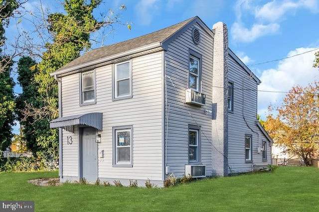 exterior space featuring central AC unit and a lawn