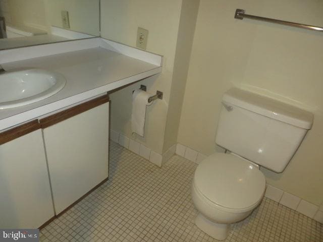 bathroom featuring vanity, toilet, and tile patterned flooring