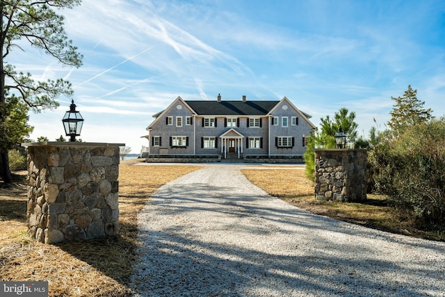 shingle-style home featuring driveway