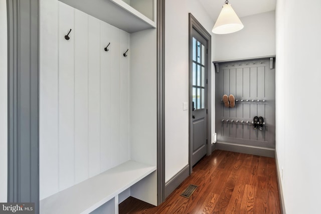 mudroom with baseboards, visible vents, and dark wood-style flooring