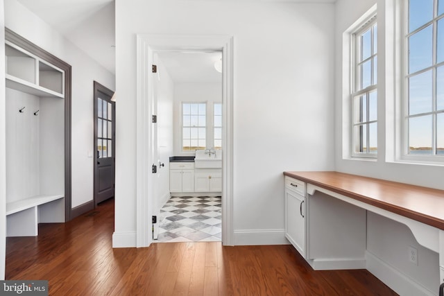 interior space featuring wood finished floors and baseboards