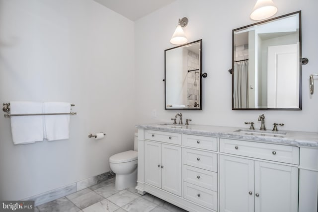 full bath featuring toilet, baseboards, marble finish floor, and a sink