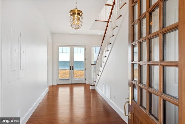 entryway with visible vents, baseboards, stairs, french doors, and dark wood-style floors