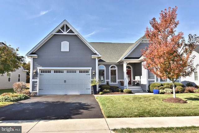 view of front of property with a front yard and a garage