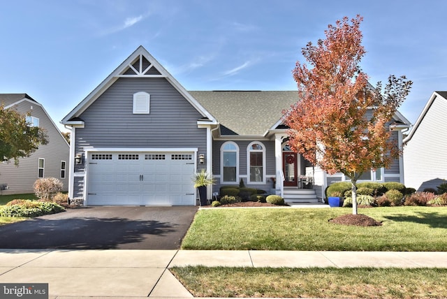 view of front of house with a front yard and a garage