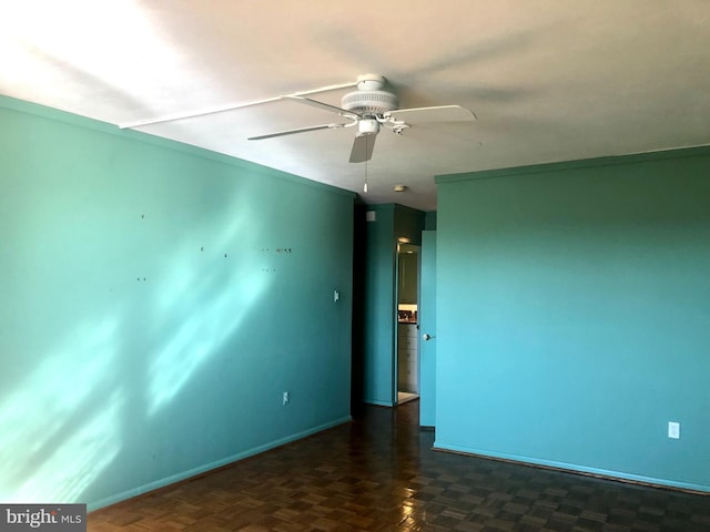 unfurnished room featuring dark parquet floors and ceiling fan