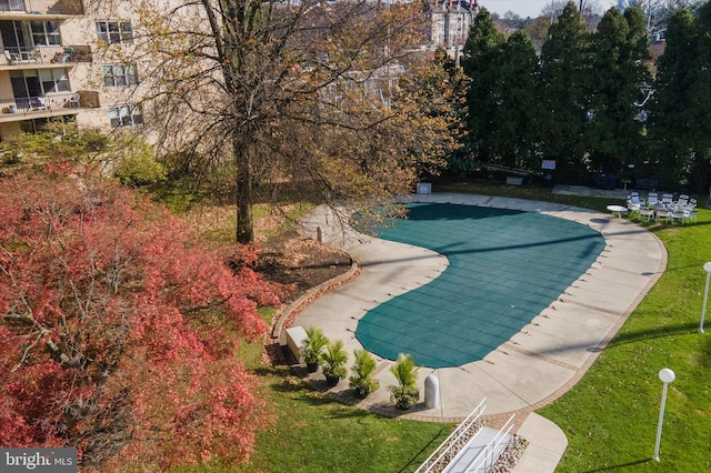 view of home's community with a lawn and a swimming pool