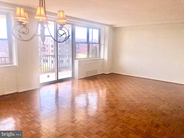 unfurnished dining area featuring baseboards and a chandelier