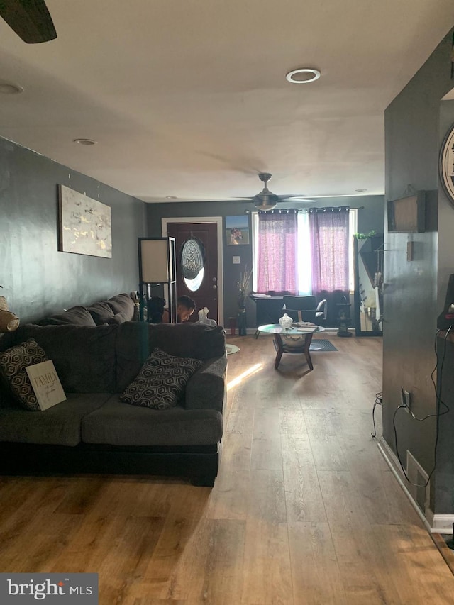 living room featuring hardwood / wood-style floors and ceiling fan