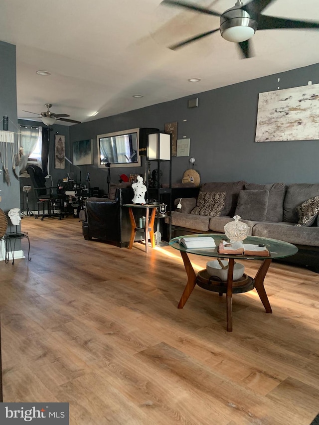 living room with hardwood / wood-style flooring and ceiling fan