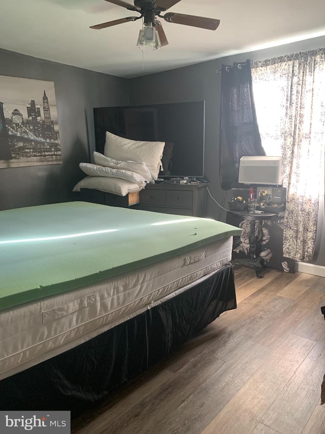 bedroom featuring wood-type flooring and ceiling fan