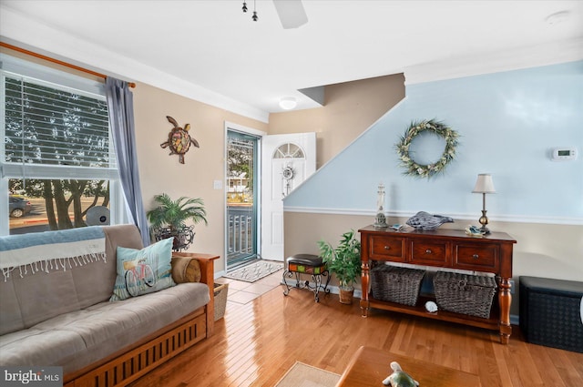 sitting room featuring light wood-type flooring, a wealth of natural light, and ceiling fan