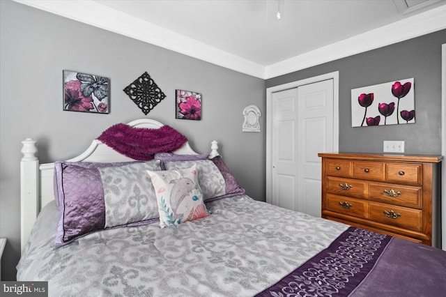 bedroom with a closet and crown molding