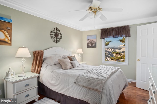 bedroom with ceiling fan, dark hardwood / wood-style flooring, and ornamental molding