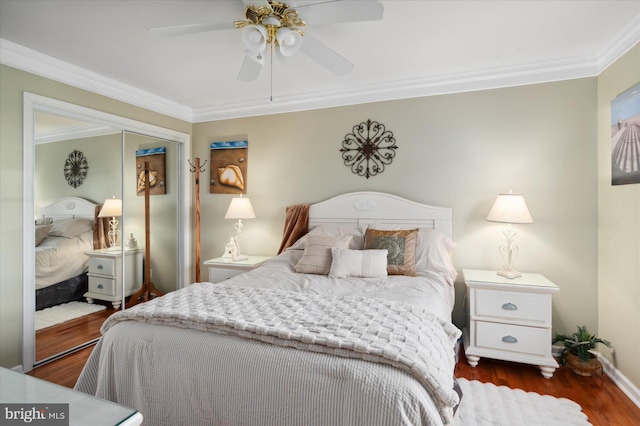 bedroom with ornamental molding, ceiling fan, and dark hardwood / wood-style floors